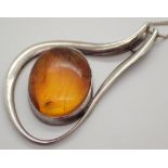 Imported silver amber necklace with insect inclusion on silver curb necklace