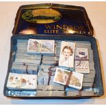 Vintage tin containing a quantity of Wills cigarette cards
