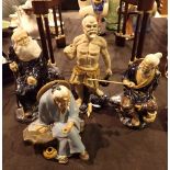 Four vintage Oriental Mudmen figurines