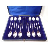 Cased set of twelve hallmarked silver spoons and a pair of tongs