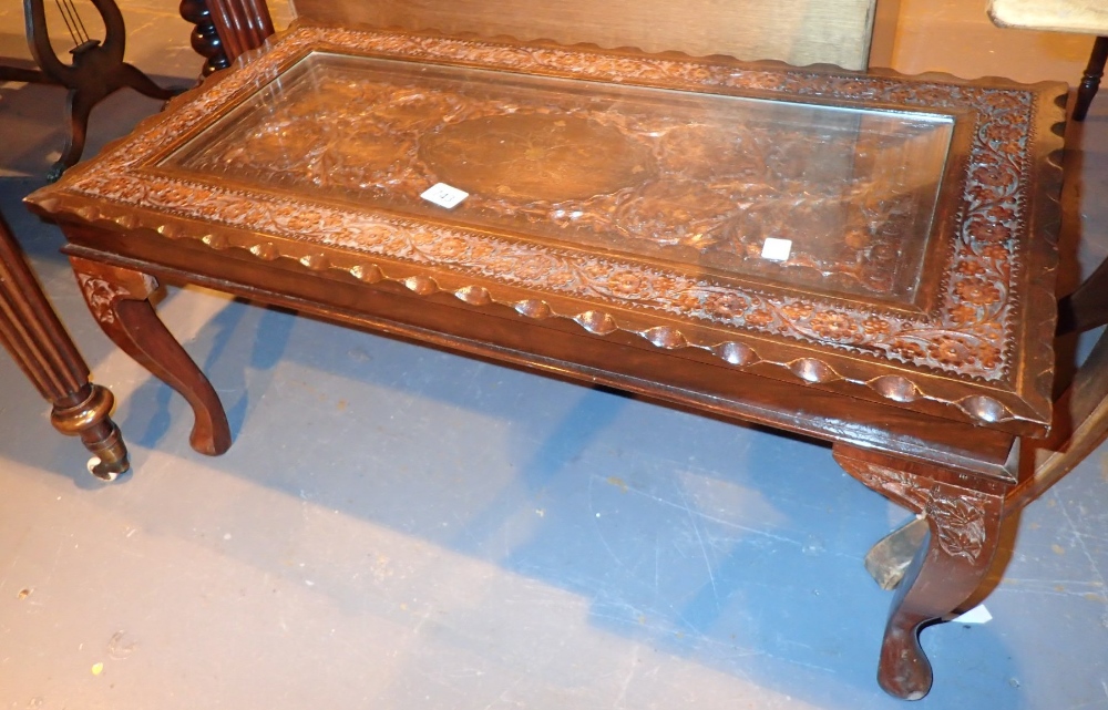 Carved hardwood Oriental style coffee table with brass inlay