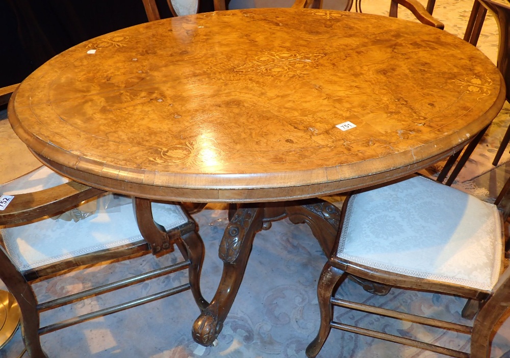 Inlaid burr walnut inlaid tilt top on heavily carved base