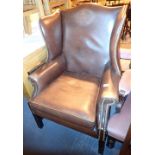 Brown leather upholstered wingback chair