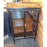 Oriental black lacquered cabinet with glazed doors two shelves and gilt and red decoration