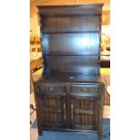 Dark oak small dresser with two drawers over two cupboards