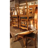 Teak circular dining table with brass paw feet and six dining chairs