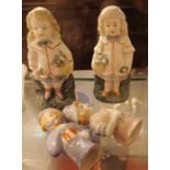 Two small staffordshire style child figurines and two pan cushion figurines
