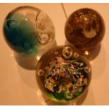 Three vintage glass paperweights including caithness