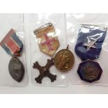 Four mixed vintage medals including an e