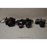 Four Canon cameras with lenses. Camera bodies include: EOS 650 (1105477); EOS 500 (1309150); AT-1 (