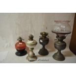 A quantity of oil lamp parts including shades and reservoirs.