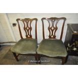 A pair of Chippendale style mahogany dining chairs.