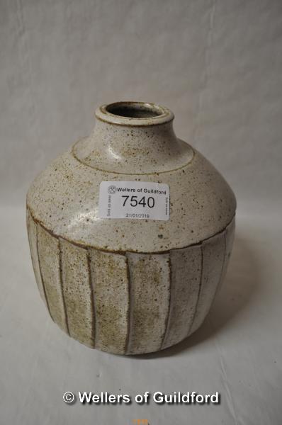 A stoneware fluted vase in the style of David Leach, with white speckled glaze and fluted sides,