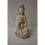 A Chinese blanc de chine figure of Guanyin seated on a lotus flower, 27cm.