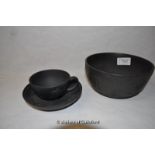 A Wedgwood black basalt bowl and similar cup and saucer, both impressed.