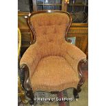 A Victorian mahogany framed spoonback armchair on carbriole legs.