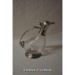 A glass ewer with white metal mounts stamped 95%.