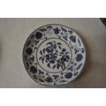 A Chinese blue and white disg decorated with flowers, six character mark to base, 22cm diameter.