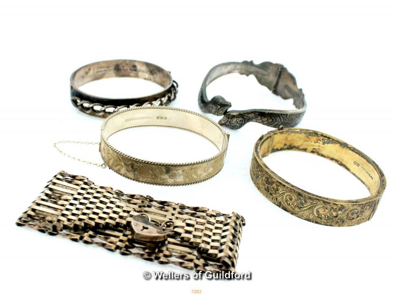 An assortment of Silver Bangles and a Silver Gate Chain Link Bracelet with Heart Padlock Clasp,