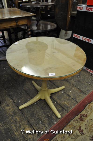 A cast iron quadruped pub table base with plywood and glass tops, 61.5cm diameter.