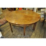 A large 19th Century circular mahogany dining table with gateleg action, later crossbanding and with