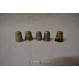 Two silver thimbles and three others.