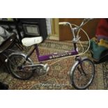 Vintage Trusty Typhoon bicycle with purple paintwork and chrome mounts.