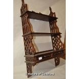 A mahogany wall shelf with two small drawers.