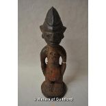 A west African tribal carved wooden figure of a man, 24.5cm.