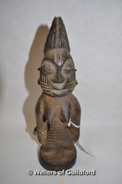 An African carved wooden fertility figure, 23cm.