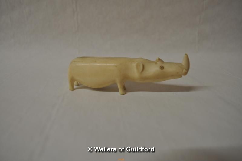 A carved bone rhino, 10cm long.