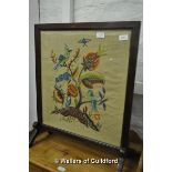 A 1920's firescreen with woolwork panel.