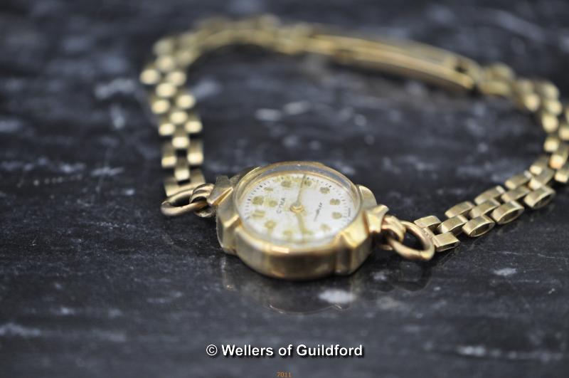 A lady's 9ct gold wrist watch by Cyma with chain link bracelet.