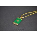 A jade pendant with chinese inscription on gold plated chain