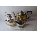 A three piece silver plated tea set and a similar cream jug.