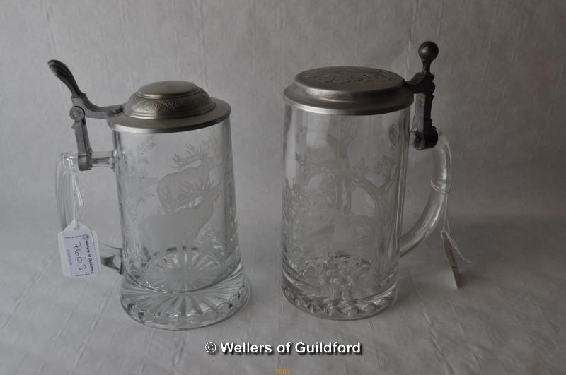 Two modern German glass steins etched with stags, metal lids.