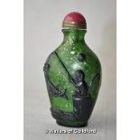 A Chinese green glass snuff bottle moulded with a monkey fishing.