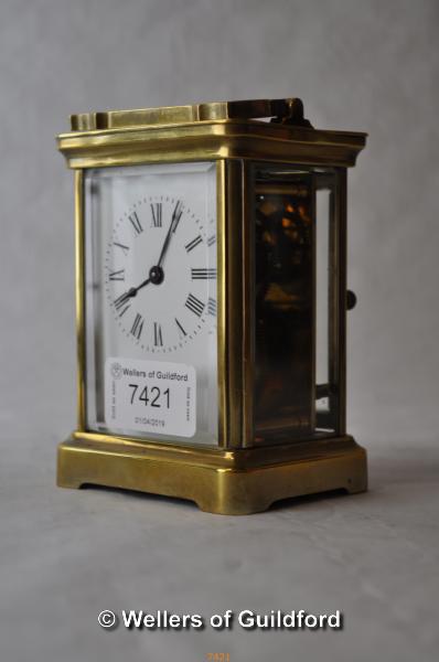 A brass carriage clock, the white enamel dial with Roman numerals, 11cm.