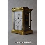 A brass carriage clock, the white enamel dial with Roman numerals, 11cm.