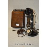 An vintage candlestick telephone with oak bell box, converted for modern use.