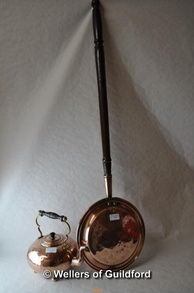 A copper warming pan and copper kettle.