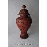 A Chinese red lacquer vase and cover, 25cm