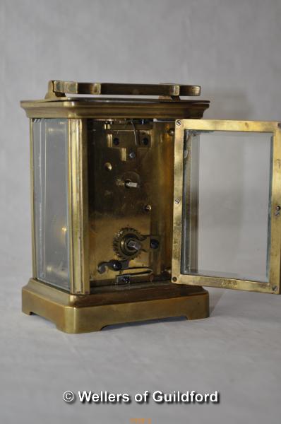 A brass carriage clock , the white enamel dial with Roman numerals, 10.75cm excluding handle. - Image 3 of 4