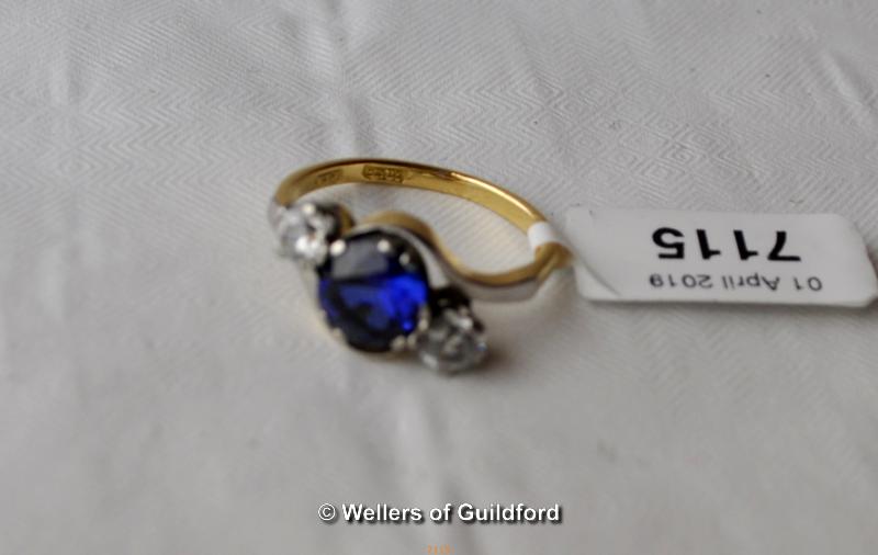 Blue stone ring flanked by cubic zircona, 18ct setting.