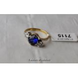 Blue stone ring flanked by cubic zircona, 18ct setting.