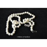 A single strand of cultured pearls with silver clasp, 22 inches.