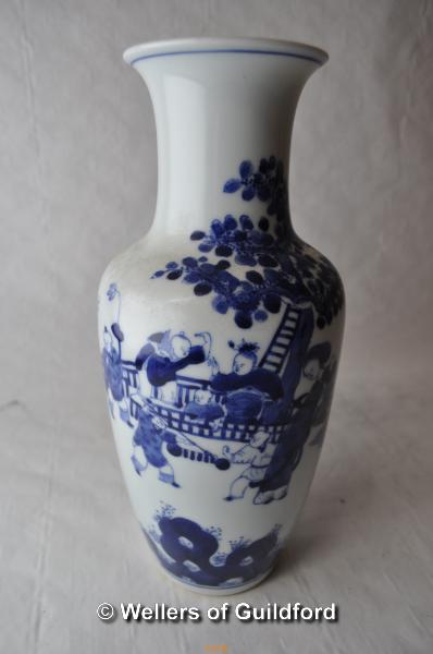 A Chinese blue and white vase decorated with children playing in a garden, 24cm.