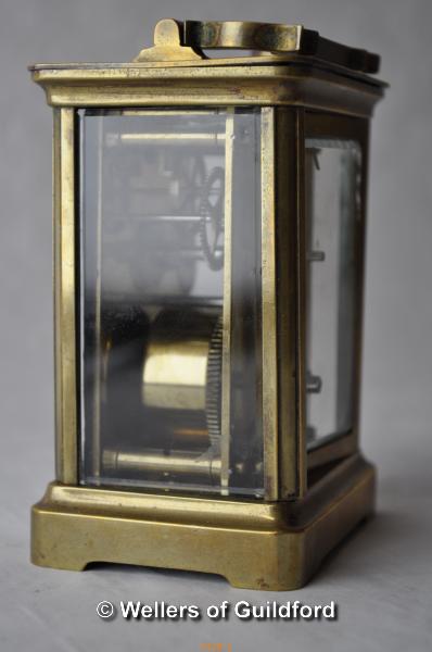 A brass carriage clock , the white enamel dial with Roman numerals, 10.75cm excluding handle. - Image 2 of 4