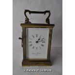 A brass carriage clock, white enamel dial Charles Frodsham, London, with key.