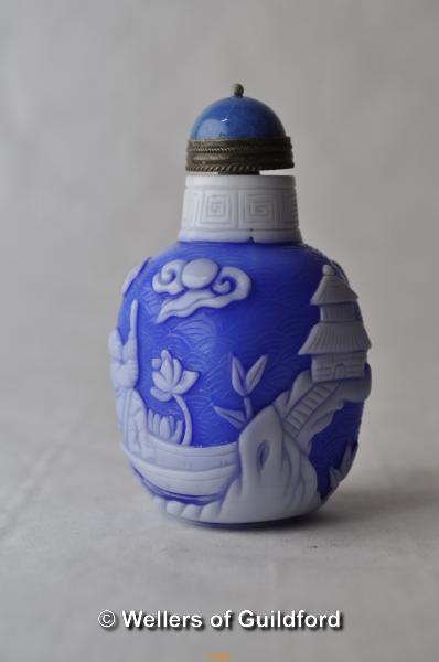 A Chinese blue and white cameo glass snuff bottle of square section.